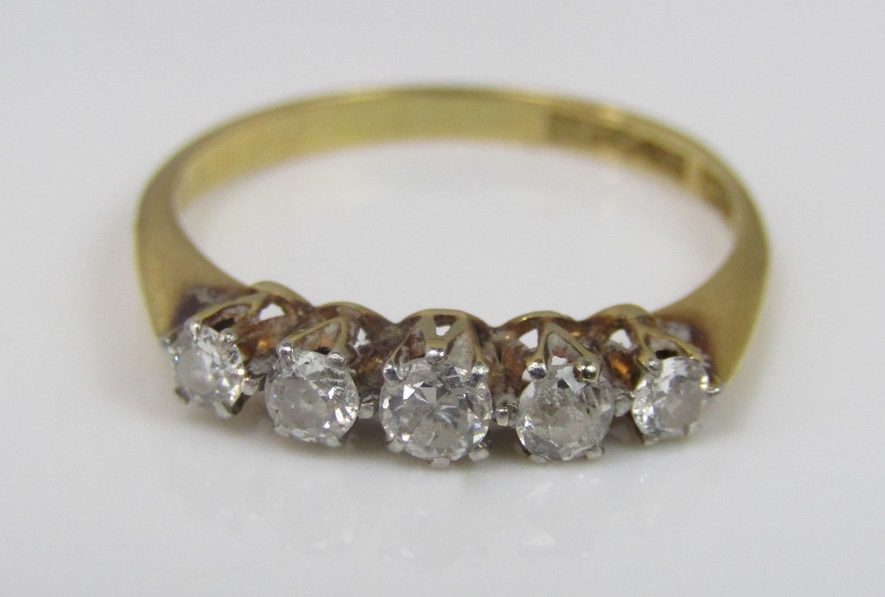 An 18ct five stone diamond ring, size M/N, 2g