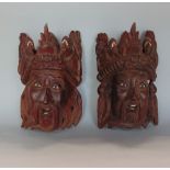 A pair of hardwood eastern masks of a gentleman in ceremonial headdress with ivory fittings, 30cm