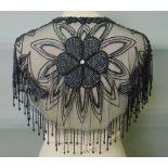 Black evening shawl with heavily beaded flower motifs and black bead fringing