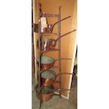 A good quality iron work floor standing saucepan stand on six graduated tiers together with a set of