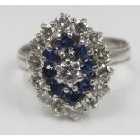 A sapphire and diamond three tier cluster ring in indistinctly marked white metal, size O/P, 5.5g