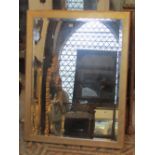 A contemporary wall mirror of rectangular form with bevelled edge plate within a simple gilt