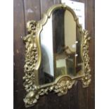 A 19th century gilt framed and shield shaped wall mirror with moulded outline and pierced