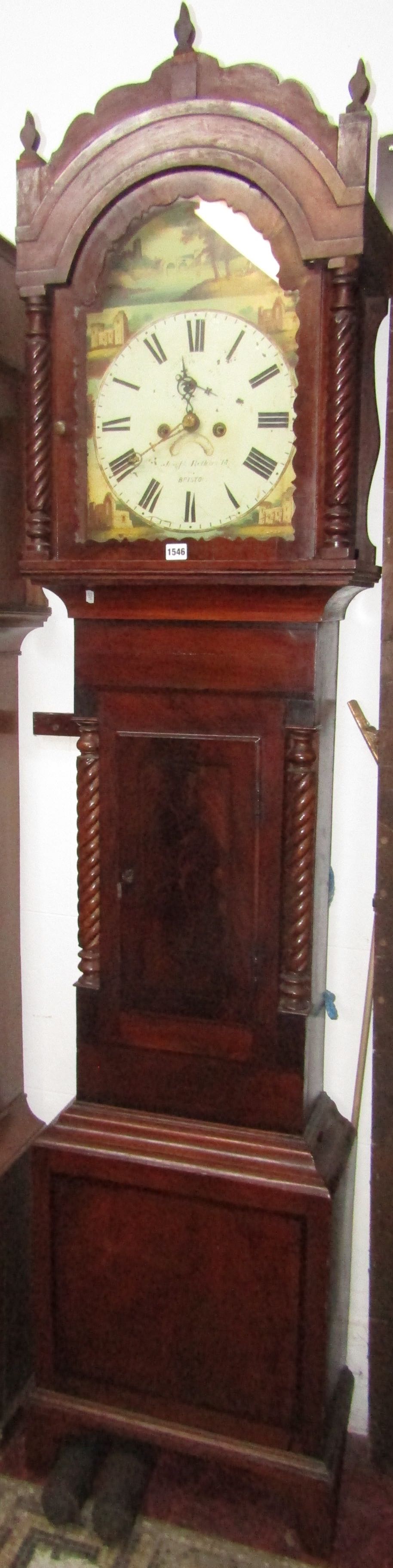 A 19th century mahogany longcase clock with spiral column supports beneath an arched frieze,