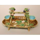 A 19th century George Jones majolica strawberry basket of rustic moulded form, with applied