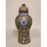 An unusual eastern pottery vase and cover of shouldered form with painted blue and white stylised