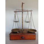 An unusual set of 19th century brass and mahogany twin balance scales, with four pans and weights