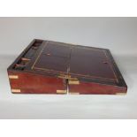 A substantial Victorian mahogany lap desk with fitted interior and brass bounded borders and mounts