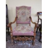 A scroll armed elbow chair in beechwood, with hand worked tapestry seat and back, raised on lion paw