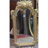 A reproduction wall mirror, the gilt moulded frame with scrolling acanthus, raised face mask and