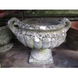 A good quality weathered cast composition stone campana shaped garden urn with scrolled loop