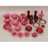 A collection of Cranberry glass to include many ribboned examples