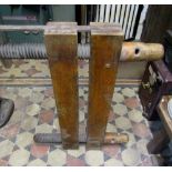 A substantial wooden twin screw clamp with iron strap fittings, stamped Hampson Bettridge & Co