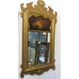 A Georgian style wall mirror, the moulded gilt frame with fret carved outline enclosing a mirror