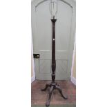 A good quality early 20th century lamp standard with turned and fluted column raised on a well