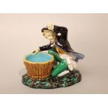 A 19th century Minton's majolica basket with applied figure of a kneeling brown jacketed boy, raised