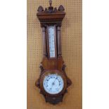 Early 20th century oak aneroid barometer thermometer in an architectural case with cornithian