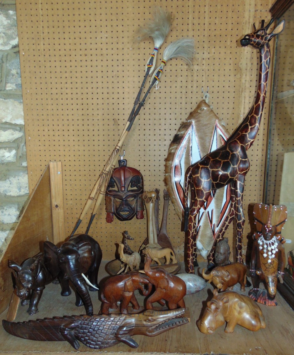 A collection of African treen carvings to include tribesmen, animals, etc