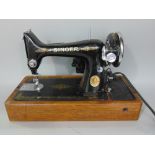 Vintage Singer sewing machine within a leather wrapped hardwood case