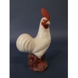 An oriental pottery model of a white cockerel, raised on a pierced base, 36cm tall