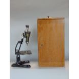 A Beck of London binocular microscope within a case, 41cm high