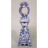 A late 19th century tin glazed earthen ware Delft type watch case in the form of a longcase clock,