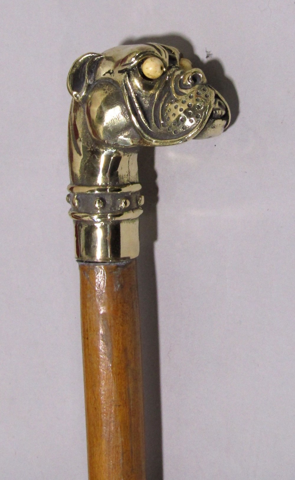 Malacca walking stick with cast brass humorous dog head finial with bone eyes
