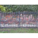 A pair of good quality heavy iron work entrance gates with vertical rails and scroll detail, 10ft
