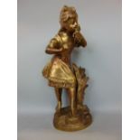 Gilt bronze study of a standing girl holding a bird, 40cm high