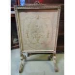 A fire screen of rectangular form, the moulded and carved frame with decorative classical tied