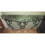 A console table, the green and white flecked coloured marble top with serpentine moulded front