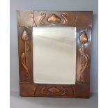 A good arts and crafts/art nouveau embossed copper wall mirror in the manner of Archibald Knox for
