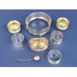 A mixed collection of silver to include a pierced silver dish sleeve, embossed silver cream jug,