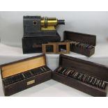 A cased brass and sheet metal magic lantern together with three boxes of slides