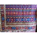 A chain stitch rug or wall hanging with geometric detail of banded form within running borders,