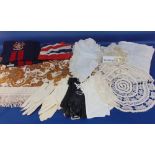 Collection of mixed textiles including white table linen, vintage leather gloves, a union jack flag,