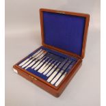 Mahogany cased mother of pearl handled silver plated canteen of cutlery, in two layers twelve knives