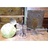 An unusual wrought iron rush nip and double candle stand in wrought iron, raised on a circular base,