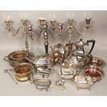 A box containing a collection of silver plated items to include three twin branch candelabra, tea