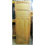 A reclaimed stippled pine interior panelled door, together with a polished brass fender, a further