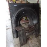 A Victorian cast iron fire insert, the arched centre with decorative foliate surround, together with