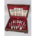 Mahogany cased canteen of cutlery with stylised Art Nouveau type handles, the box 42 cm long