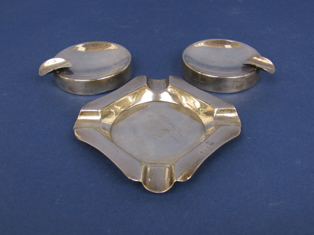 Pair of art deco silver ashtrays together with a further ashtray (3)