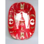 ALAN CAIGER-SMITH (1930-) AN EARLY ALDERMASTON POTTERY ROUNDED RECTANGULAR DISH PAINTED WITH RED AND