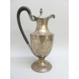 VICTORIAN SILVER CLARET JUG, THE DOMED COVER WITH URN SHAPED FINIAL, WOODEN LOOP HANDLE, BY