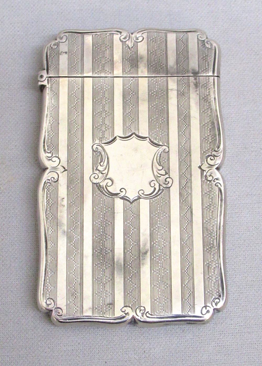 VICTORIAN SILVER ENGRAVED CARD CASE OF RECTANGULAR FORM WITH CENTRAL SHIELD CARTOUCHE TO THE FRONT