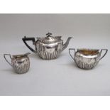 VICTORIAN SILVER THREE PIECE TEASET WITH A FLUTED BOWL AND MOULDED GADROONED RIM, HEIGHT OT TEAPOT
