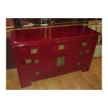 AN ORIENTAL RED LACQUERED SIDEBOARD WITH FIVE DRAWERS, TWO PANELED DOORS WITH INSET BRASS TREFOIL