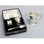 SILVER THREE PIECE CHRISTENING SET OF EGG CUP, NAPKIN RING AND SPOON BY ADIE BROTHERS, BIRMINGHAM