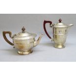 SILVER TEAPOT AND NEAR MATCHING HOT WATER POT BY W. B & S LTD, BIRMINGHAM 1935 AND AIDIE BROTHERS
